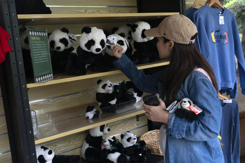 Visitor buys stuffed animals at the Smithsonian's National Zoo in Washington, Thursday, Sept. 28, 2023. (AP Photo/Jose Luis Magana)