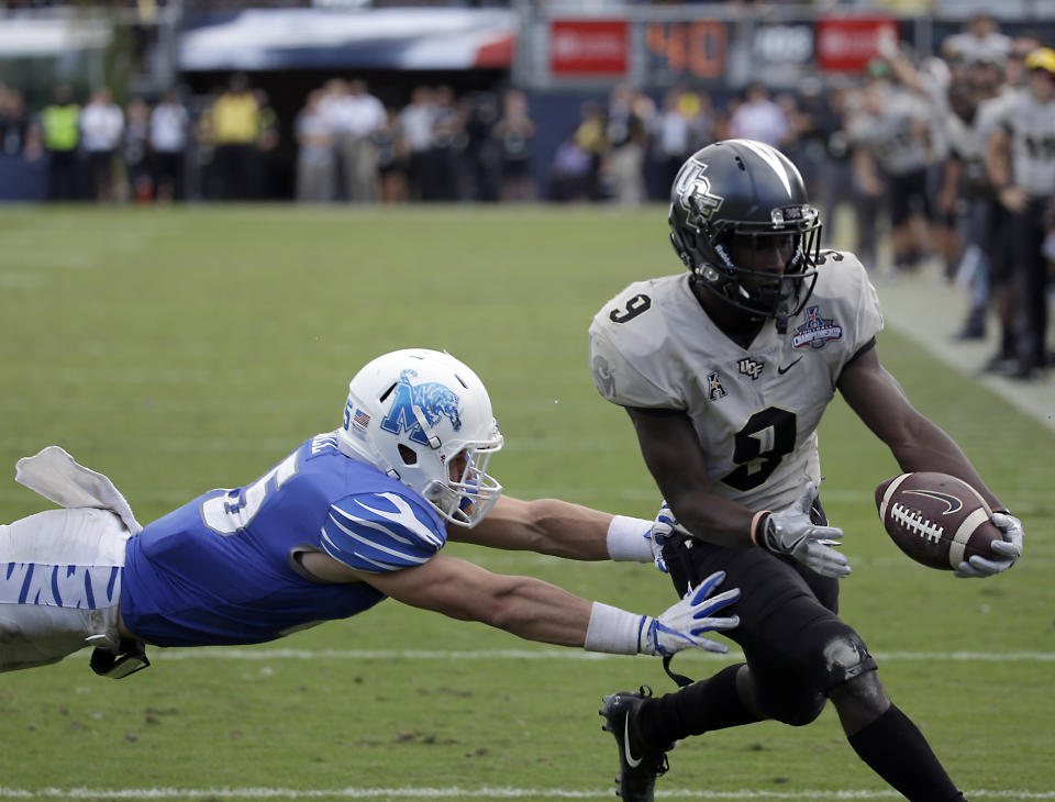 Central Florida running back Adrian Killins Jr. (9) runs for a 2-yard touchdown against Memphis. (AP Photo/John Raoux)