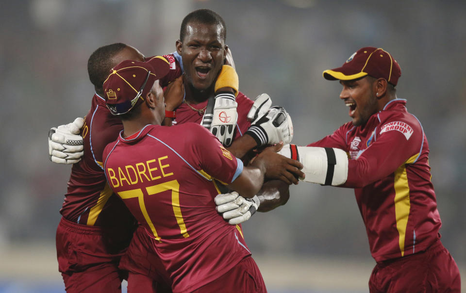 West Indies' captain Darren Sammy, center, celebrates with teammates their win over Australia in the ICC Twenty20 Cricket World Cup match in Dhaka, Bangladesh, Friday, March 28, 2014. West Indies' won the match by six wickets. (AP Photo/Aijaz Rahi)