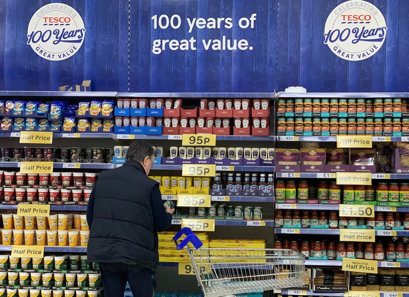 A man looks at products on a shelf inside Tesco Extra superstore near Manchester