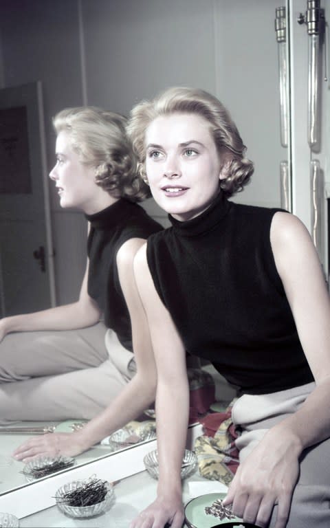 Grace Kelly doing excellent Wasp style in chinos and a black sleeveless top.  - Credit: Gene Lester. /Getty. 