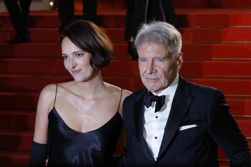 CANNES, FRANCE - MAY 18: Phoebe Waller-Bridge and Harrison Ford depart the &quot;Indiana Jones And The Dial Of Destiny&quot; red carpet during the 76th annual Cannes film festival at Palais des Festivals on May 18, 2023 in Cannes, France. (Photo by Mike Coppola/Getty Images)