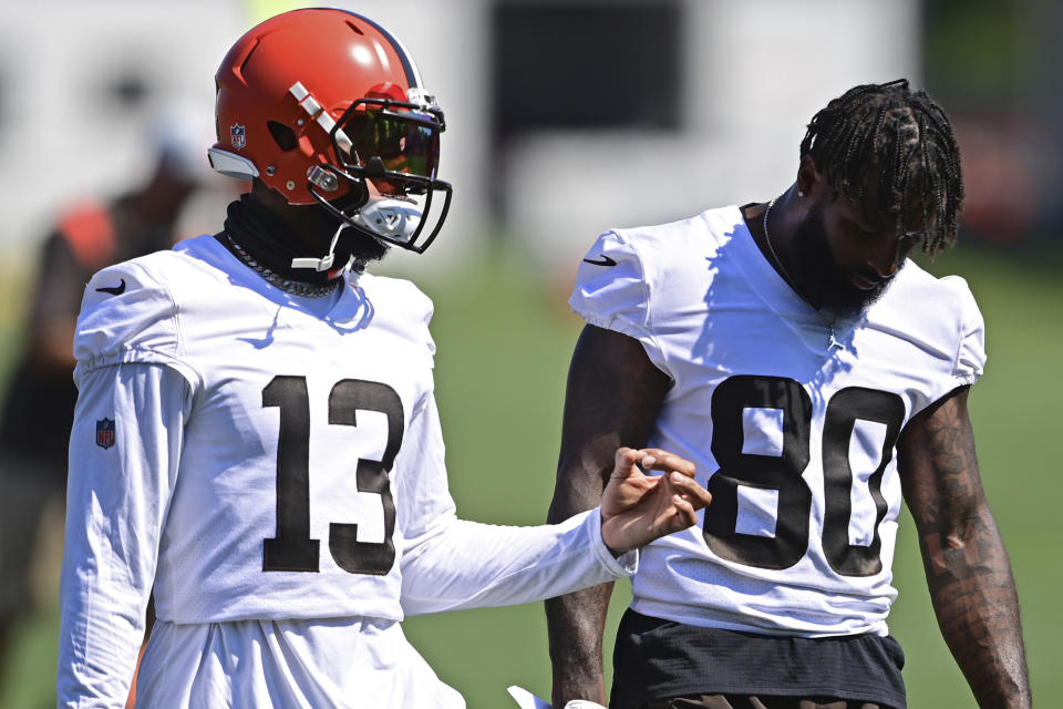 Cleveland Browns wide receiver Odell Beckham Jr. (13) talks with Jarvis Landry during an NFL football practice in Berea, Ohio, Tuesday, Aug. 24, 2021. (AP Photo/David Dermer)