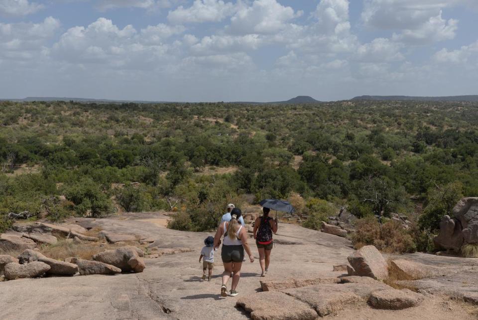TKTK did not feel deterred by the heat as they hiked down Enchanted Rock's summit at Enchanted Rock State Natural Area, located north of Fredericksburg, on a hot summer day, July 26, 2023.