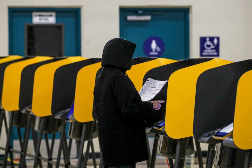 Los Angeles, CA - November 08: A voter goes over her ballot choices while voting at Ruben F. Salazar Park polling station on Tuesday, Nov. 8, 2022 in Los Angeles, CA. (Irfan Khan / Los Angeles Times)