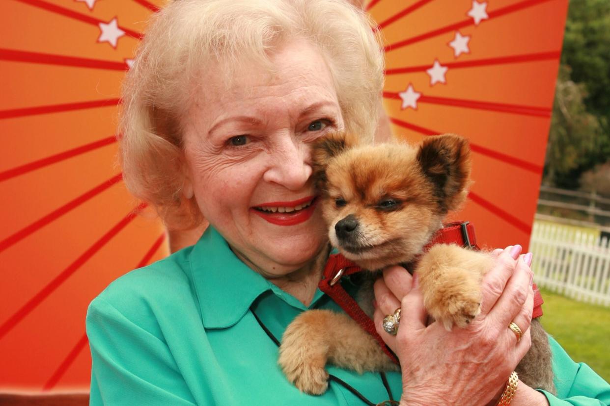 Betty White holding dog