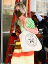 <p>Nixon aka Miranda Hobbes was spotted on set in a colourful Dries Van Noten dress (now reduced, online) accessorised with a tote bag emblazoned with a picture of Bernie Sanders and the text 'Justice For All'. Very fitting for the woman who, in real life, ran for New York City mayor. </p><p><a class="link " href="https://www.net-a-porter.com/en-gb/shop/product/dries-van-noten/dorias-drawstring-tie-dyed-striped-faille-midi-dress/1316836" rel="nofollow noopener" target="_blank" data-ylk="slk:SHOP NOW;elm:context_link;itc:0;sec:content-canvas">SHOP NOW</a> Dries Van Noten Dorias dress, £47.50</p>