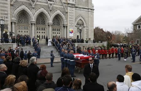 Pallbearers remove the Canadian flag from the casket of Warrant Officer Patrice Vincent following his funeral in Longueuil, Quebec November 1, 2014. REUTERS/Chris Wattie