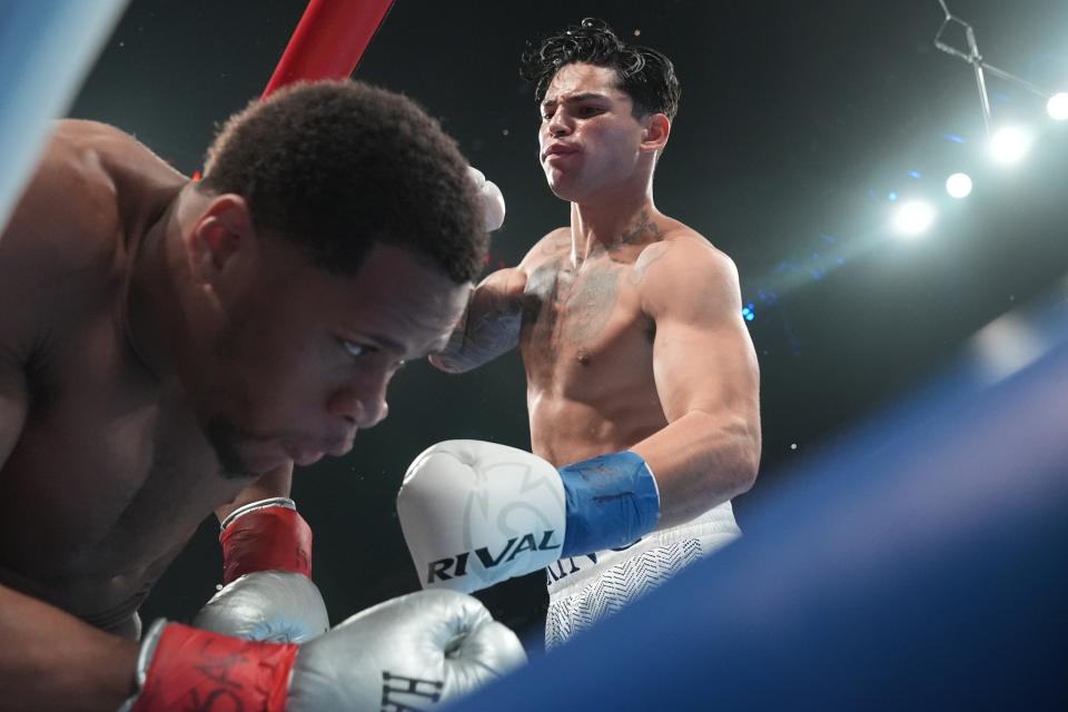 Ryan Garcia, right, punches Devin Haney during the first round of a super lightweight boxing match early Sunday, April 21, 2024, in New York. (AP Photo/Frank Franklin II)