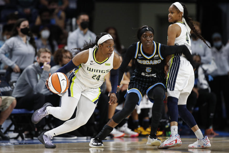 Dallas Wings guard Arike Ogunbowale (24) drives to the basket against Chicago Sky guard Kahleah Copper (2) during the first half in the first round of the WNBA basketball playoffs, Thursday, Sept. 23, 2021, in Chicago. (AP Photo/Kamil Krzaczynski)