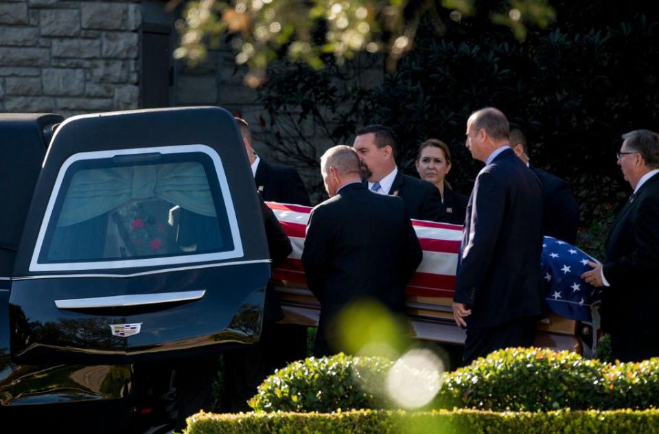 2) Bush's casket is carried into the hearse.