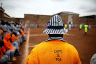 A Kenyan prisoner wearing a shirt with the words "Crime is not good" watches a mock world cup soccer match between Russia and Saudi Arabia, as part of a month-long soccer tournament involving eight prison teams at the Kamiti Maximum Prison, Kenya's largest prison facility, near Nairobi, Kenya, June 14, 2018. REUTERS/Baz Ratner