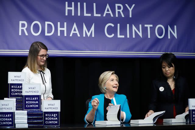 <p>John Lamparski/WireImage</p> Clinton signing 'What Happened' in 2017