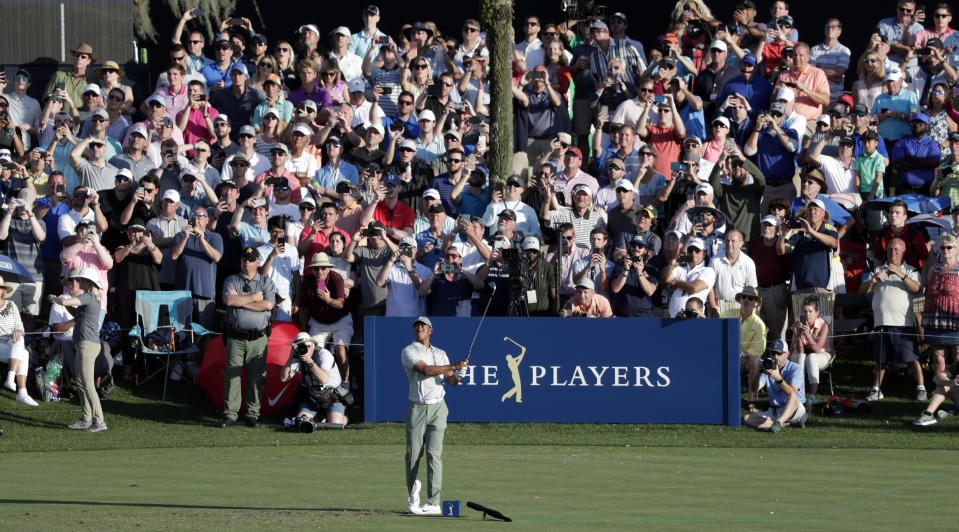 The gallery watches Tiger Woods tee off on the 17th hole during the first round of The Players Championship golf tournament Thursday, March 14, 2019, in Ponte Vedra Beach, Fla. (AP Photo/Lynne Sladky)