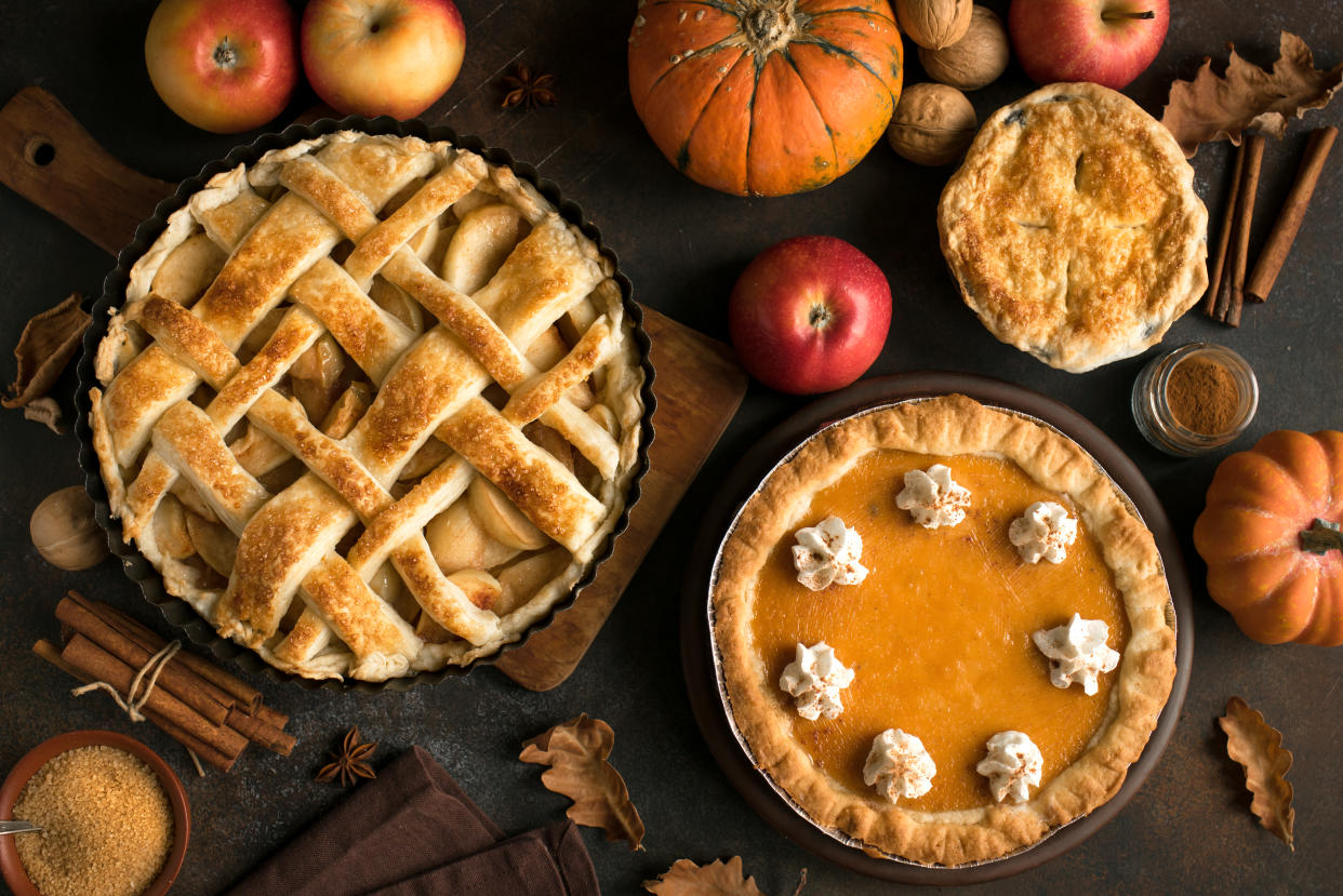 Thanksgiving pumpkin and apple various pies, top view, copy space. Fall traditional homemade apple and pumpkin pie for autumn holiday.