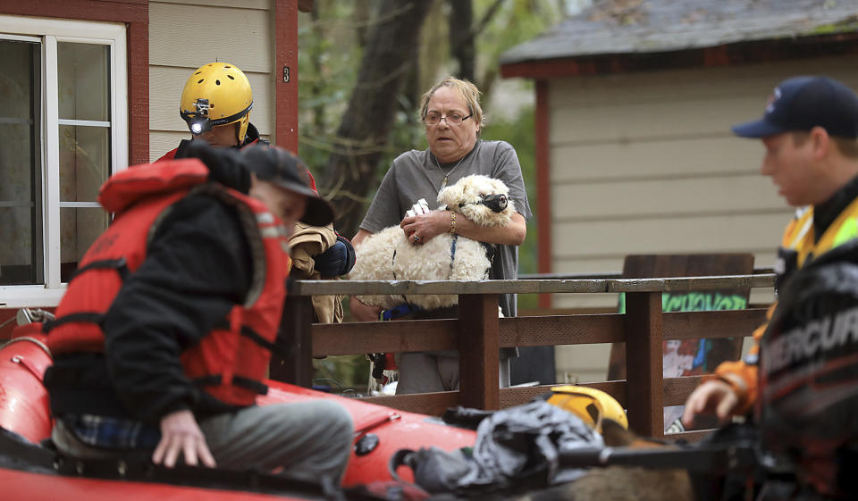 Ryan Lance, left, and Anthony Nash of the Russian River Fire Protection District swift water rescue team rescue residents of Sycamore Court Apartment in lower Guerneville, Calif., Feb. 27, 2019. (Photo: Kent Porter/The Press Democrat/AP)