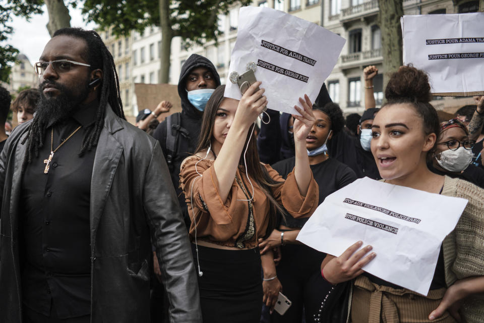 People demonstrate in Lyon, central France, Saturday, June 6, 2020, to protest against the recent killing of George Floyd by police officers in Minneapolis, USA, that has led to protests in many countries and across the US. Further protests are planned over the weekend in European cities, some defying restrictions imposed by authorities due to the coronavirus pandemic. (AP Photo/Laurent Cipriani)