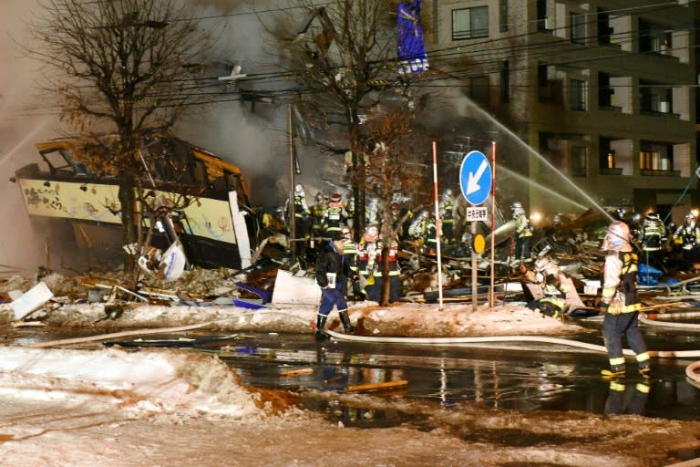 Firefighters work at the scene after an explosion at a restaurant in Sapporo, in the northern Hokkaido prefecture on December 16, 2018