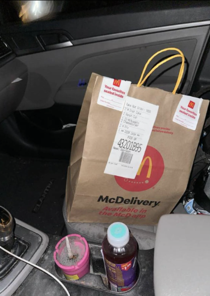 McDonald's delivery bag with a long receipt attached inside a car