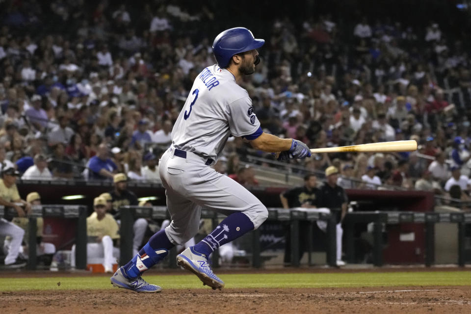 Los Angeles Dodgers' Chris Taylor watches his two-run triple against the Arizona Diamondbacks in the seventh inning during a baseball game, Friday, July 30, 2021, in Phoenix. (AP Photo/Rick Scuteri)