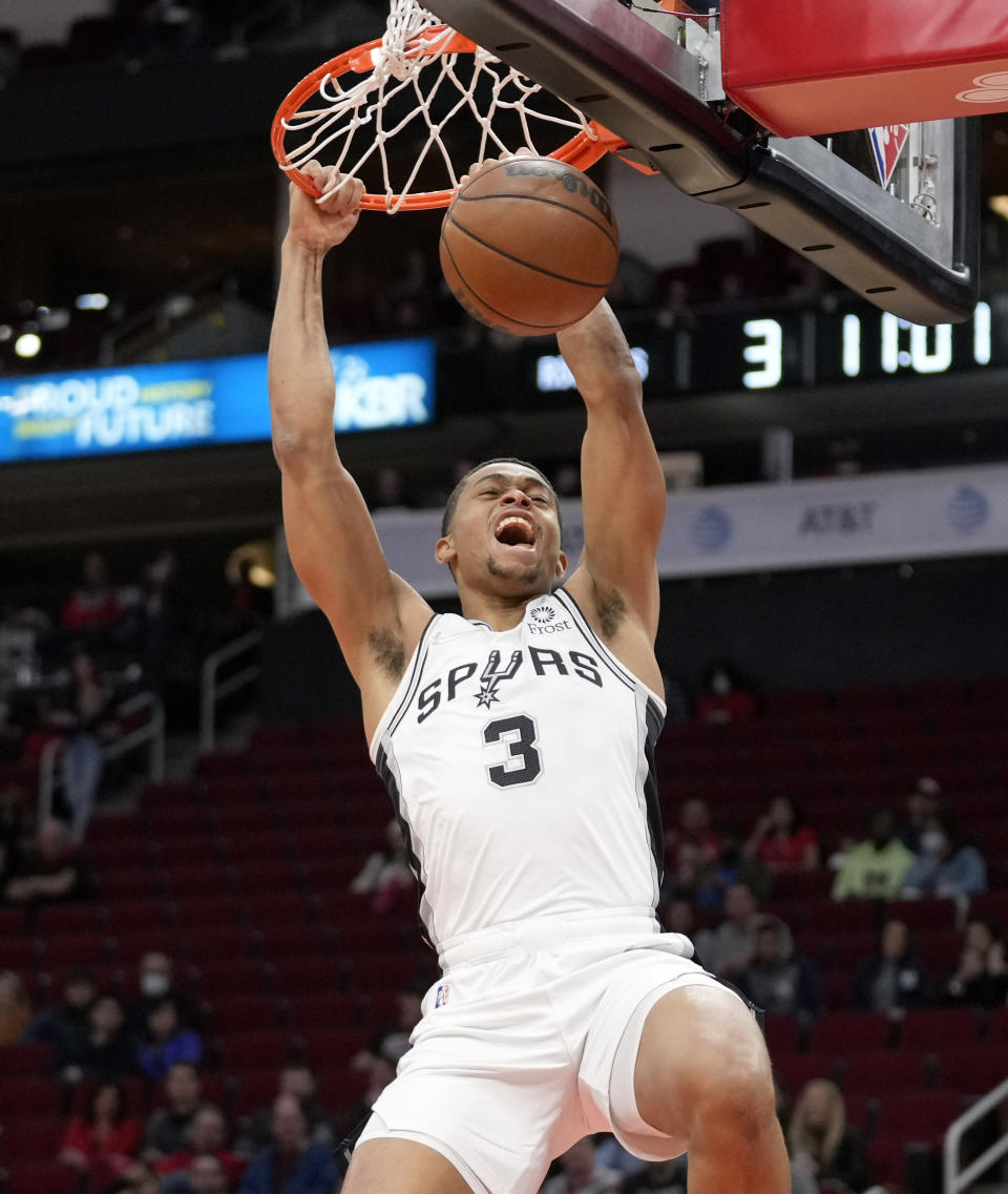 San Antonio Spurs forward Keldon Johnson dunks during the first half of an NBA basketball game against the Houston Rockets, Tuesday, Jan. 25, 2022, in Houston. (AP Photo/Eric Christian Smith)