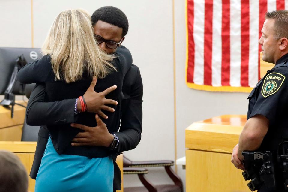 Botham Jean's younger brother Brandt Jean hugs convicted murderer and former Dallas police officer Amber Guyger.
