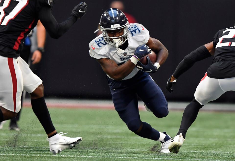 Tennessee Titans running back Darrynton Evans (32) Russell the ball during the first quarter of a preseason game at Mercedes-Benz Stadium Friday, Aug. 13, 2021 in Atlanta, Ga.  