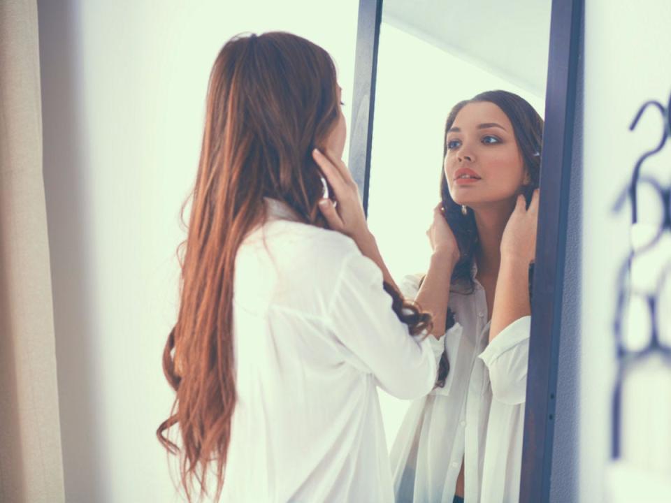 woman looking in mirror