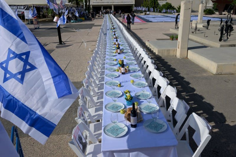 Families of hostages held by Hamas in Gaza welcome the Shabbat, the Jewish Sabbath, at a symbolic table with 203 empty chairs. The display was set up near the Tel Aviv Museum on Friday. Photo by Debbie Hill/UPI