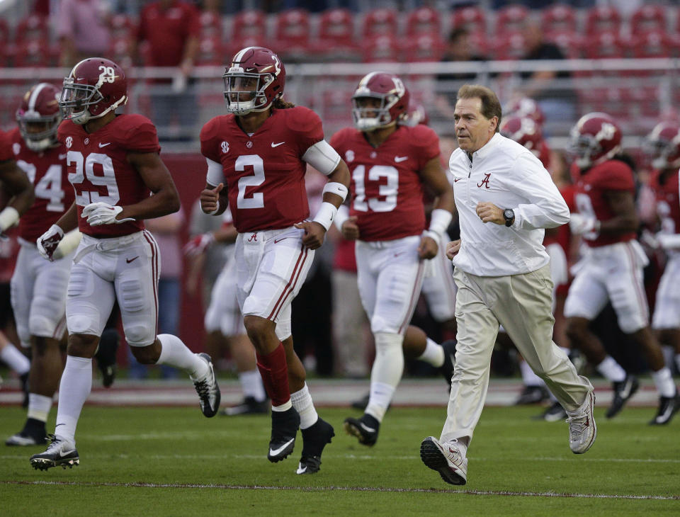 FILE – In this Saturday, Oct. 14, 2017, file photo, Alabama coach Nick Saban and quarterback Jalen Hurts (2) runs onto the field before the team’s NCAA college football game against Arkansas in Tuscaloosa, Ala. No. 1 Alabama and No. 3 Georgia are on track to give the SEC two undefeated teams in the championship game for the first time since 2009. (AP Photo/Brynn Anderson, File)