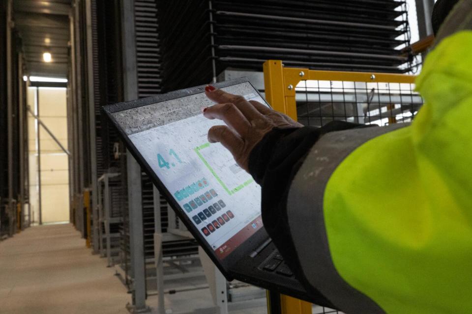 An Heirloom worker monitors a laptop