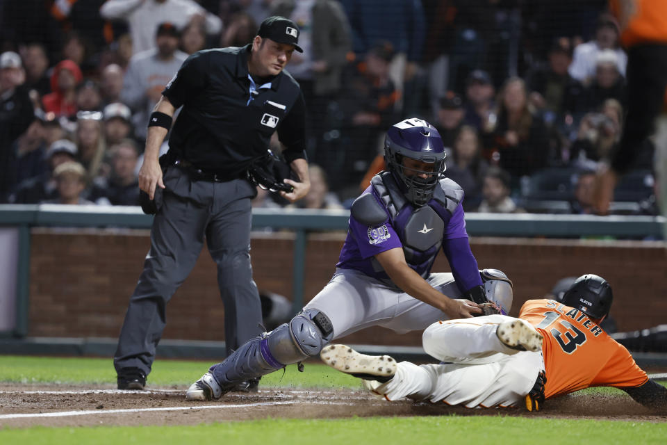 Colorado Rockies catcher Elias Diaz tags out San Francisco Giants' Austin Slater (13) at home plate during the sixth inning of a baseball game in San Francisco, Friday, July 7, 2023. (AP Photo/Josie Lepe)