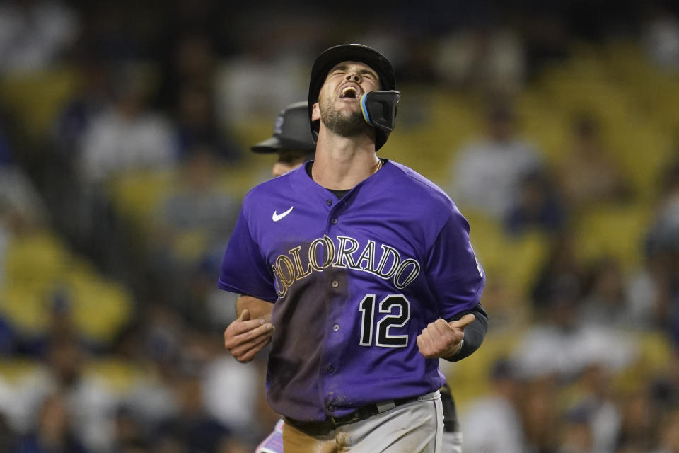 Colorado Rockies' Sean Bouchard (12) reacts after scoring off of a single hit by Michael Toglia during the ninth inning of a baseball game against the Los Angeles Dodgers in Los Angeles, Monday, Oct. 3, 2022. (AP Photo/Ashley Landis)