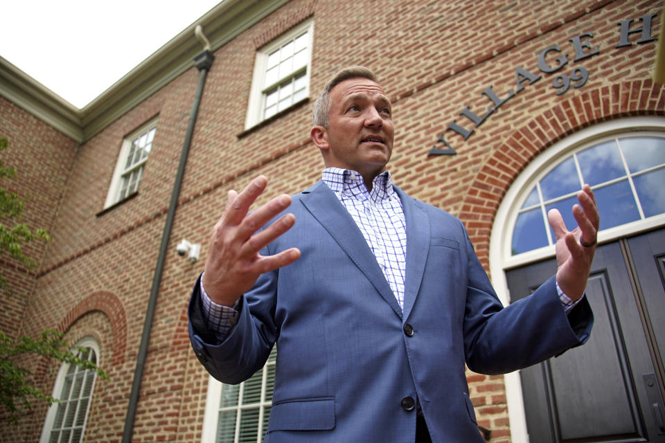 New Albany, Ohio Mayor Sloan Spalding talks with a reporter outside New Albany Village Hall in New Albany, Ohio, on Thursday, June 9, 2022. Spaulding understands the loss that people are experiencing, especially those leaving their rural “forever homes” of decades or more. But Ohio, which just lost another congressional seat and has static population, could be transformed by Intel, he said. (AP Photo/Gene J. Puskar)