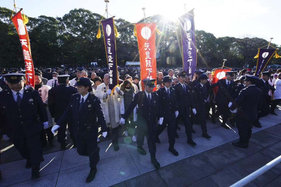 Well-wishers walk toward the venue of Japan's Emperor Akihito's public appearance with his families at Imperial Palace in Tokyo Thursday, Jan. 2, 2020. (AP Photo/Eugene Hoshiko)