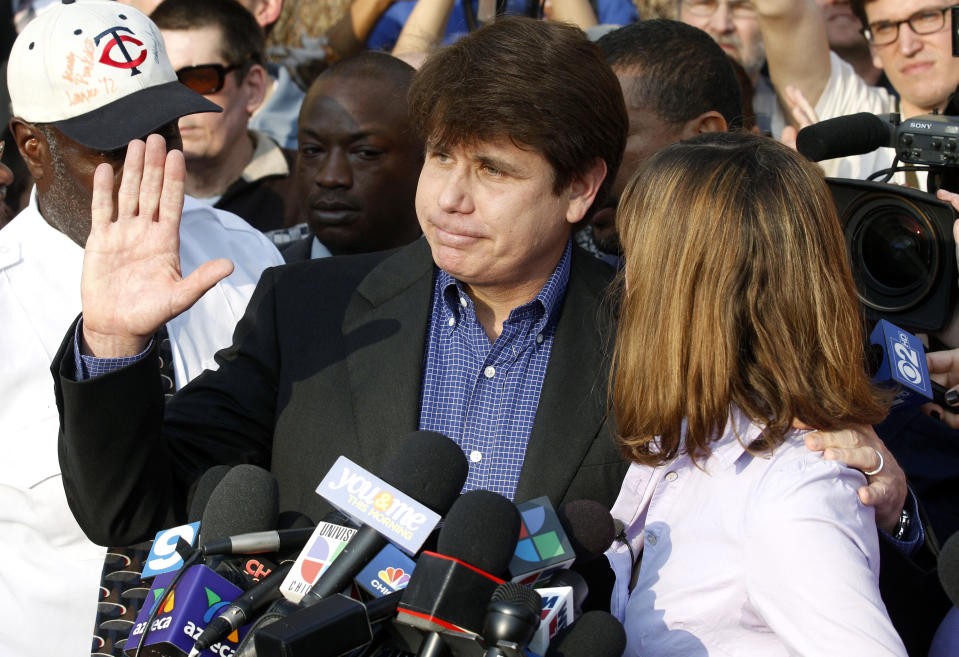 FILE - In this March 14, 2012, file photo, former Illinois Gov. Rod Blagojevich, with his wife Patti at his side, speaks to the media in Chicago before reporting to federal prison in Denver. President Donald Trump says he's "very strongly" considering commuting the sentence of Blagojevich, who is serving a 14-year prison term on multiple federal corruption convictions. Trump suggested more than a year ago that he was considering a commutation for Blagojevich, who then filed paperwork requesting a commutation. (AP Photo/M. Spencer Green, File)