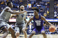 TCU guard RJ Nembhard (22) is defended by West Virginia forward Oscar Tshiebwe (34) and guard Jermaine Haley (10) during the first half of an NCAA college basketball game Tuesday, Jan. 14, 2020, in Morgantown, W.Va. (AP Photo/Kathleen Batten)