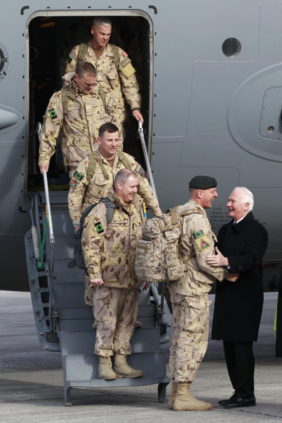 Canadian Army Major General Milner shakes hands with Canada's Governor General Johnston after arriving from Afghanistan, in Ottawa