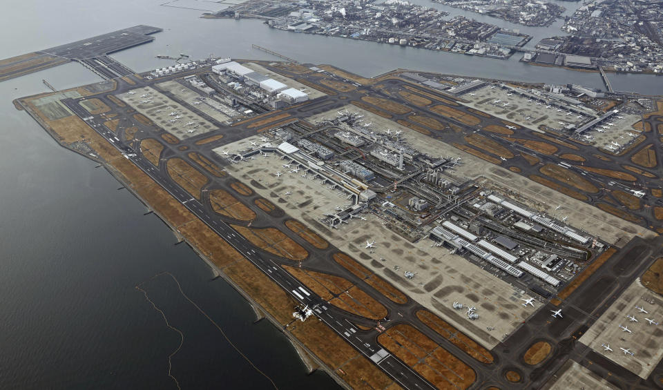 The burn-out wreckages of the Japan Airlines plane, bottom right, and the Japanese coast guard aircraft, left top, are seen at Haneda airport on Wednesday, Jan. 3, 2024, in Tokyo, Japan. The large passenger plane and the Japanese coast guard aircraft collided on the runway at Tokyo's Haneda Airport on Tuesday and burst into flames, killing several people aboard the coast guard plane, officials said. (Kyodo News via AP)