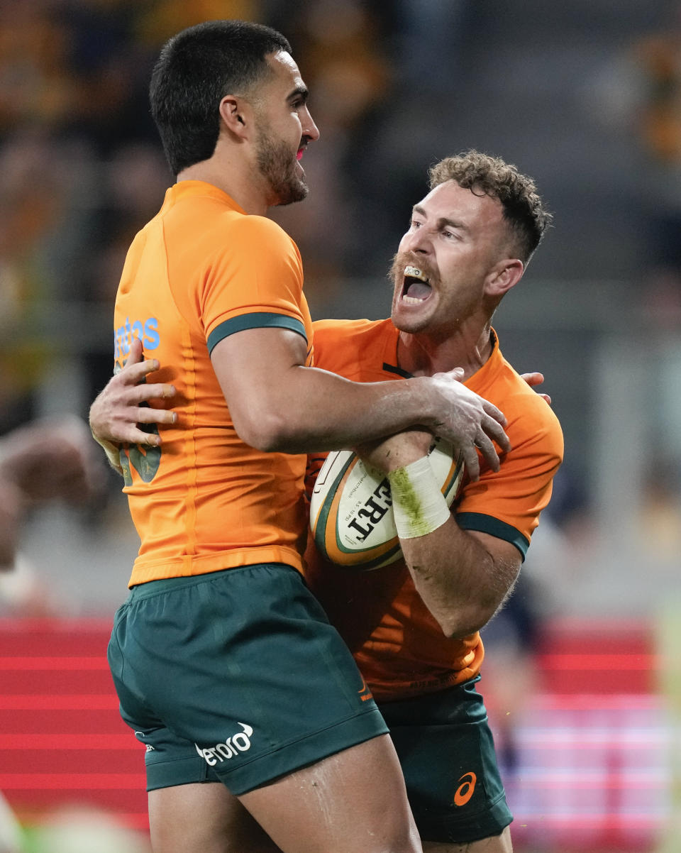 Australia's Nic White, right, is congratulated by teammate Tom Wright after scoring a try during the Rugby Championship test match between Australia and Argentina in Sydney, Australia, Saturday, July 15, 2023. (AP Photo/Rick Rycroft)