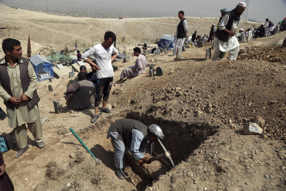 Afghan men prepare the graves for the victims of Wednesday's deadly suicide bombing that targeted a training class in a private building in the Shiite neighborhood of Dasht-i Barcha, in western Kabul, Afghanistan, Thursday, Aug. 16, 2018. The Afghan authorities have revised the death toll from the previous day's horrific suicide bombing in a Shiite area of Kabul to 34 killed. (AP Photo/Rahmat Gul)