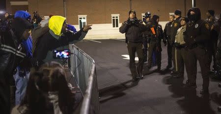 Protesters shout towards police as they demand the criminal indictment of a white police officer who shot dead an unarmed black teenager in August, outside the Ferguson Police Station in Missouri November 20, 2014. REUTERS/Adrees Latif