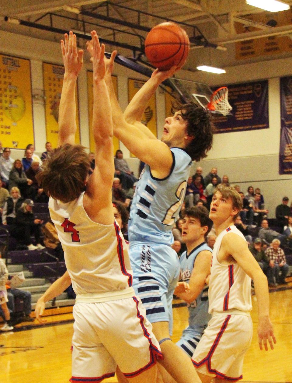 Drew Fehr goes up with a shot over Evan Houser of Pleasant Plains Saturday in their IPC-Sangamo Shootout game at Williamsville. Fehr had 5 points in a 41-27 win.