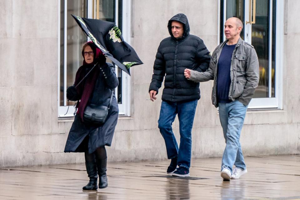 A woman struggling in the weather with amber wind alerts issued (Danny Lawson/PA Wire)