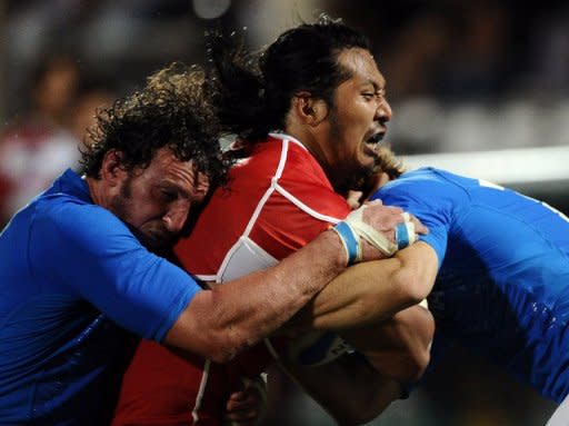 Japan's Koji Taira (C) is blocked by Italy's Mauro Bergamasco (L) and Giulio Toniolatti during their Rugby Union test match at Cesena's stadium, on August 13. Italy won 31-24