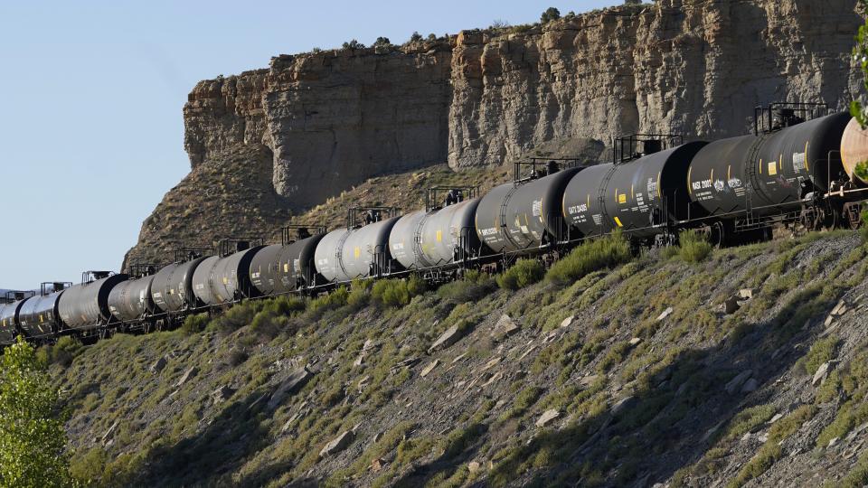 A train transports freight on a common carrier line near Price, Utah on Thursday, July 13, 2023. Uinta Basin Railway, which would connect to common carrier lines, could be an 88-mile line in Utah that would run through tribal lands and national forest to move oil and gas to the national rail network. Critics question investing billions in oil and gas infrastructure as the country seeks to use less of the fossil fuels that worsen climate change. (AP Photo/Rick Bowmer)