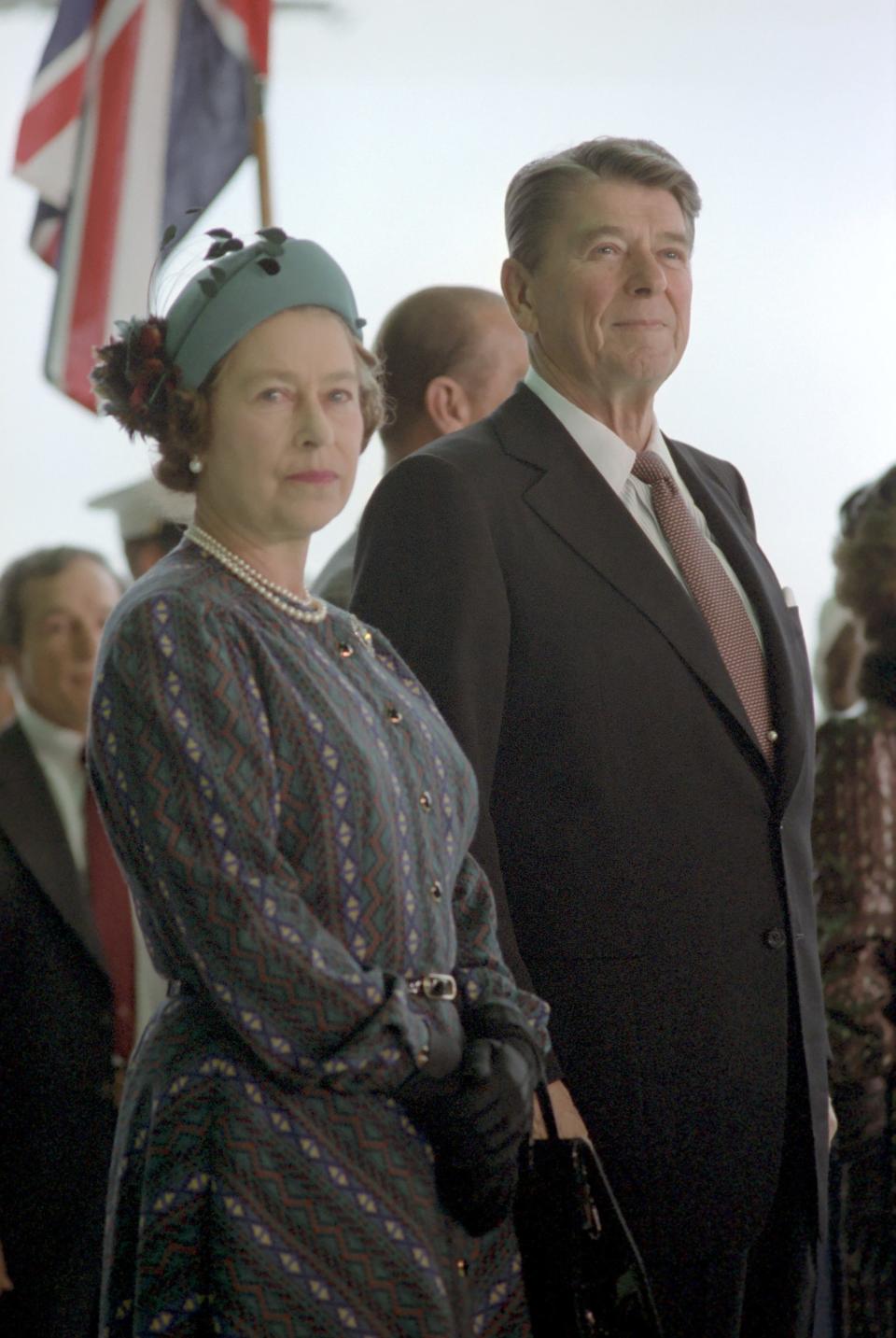 Queen Elizabeth II stands alongside President Ronald Reagan during a ceremony marking her arrival at Santa Barbara Airport in 1983.