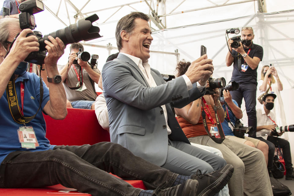 FILE - In this Sept, 3, 2021 file photo Josh Brolin, centre, takes photograph with his cell phone at the photo call for the film 'Dune' during the 78th edition of the Venice Film Festival in Venice, Italy. (Photo by Joel C Ryan/Invision/AP, File)