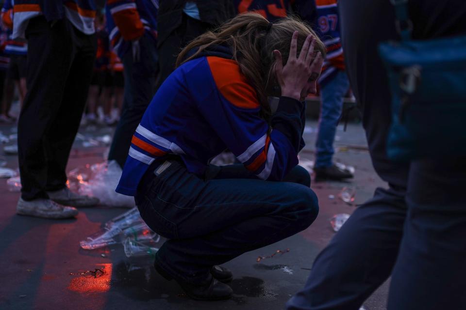 An Edmonton Oilers fan kneels in the Ice District following the team’s 2-1 loss against the Florida Panthers in Game 7 on Monday, June 24, 2024. 