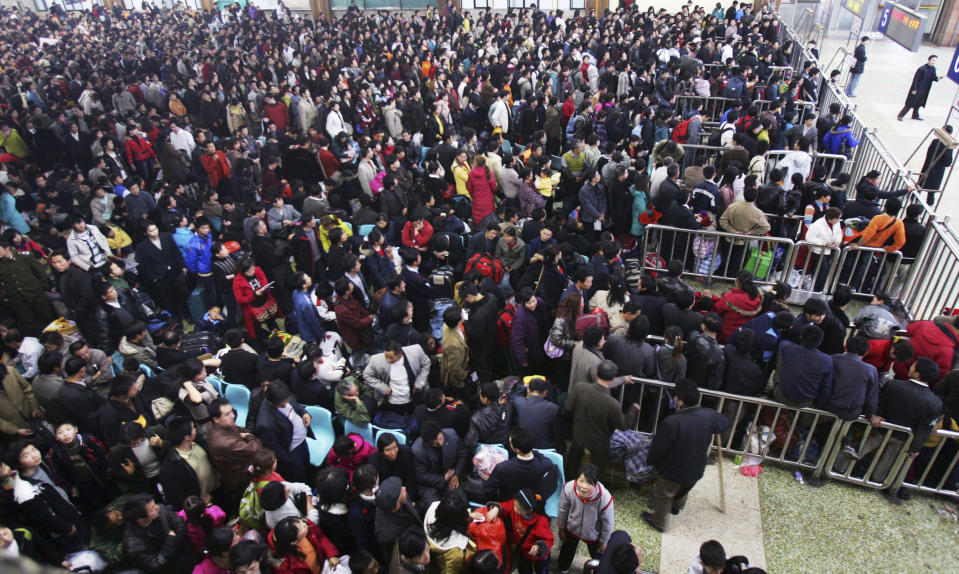 A huge crowd of people during the day. It's an aerial view.